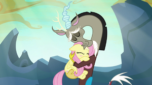 Discord and Fluttershy sharing a warm hug S6E26.png