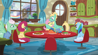 Fluttershy gives her parents a look of disbelief as Zephyr hugs her S6E11.png